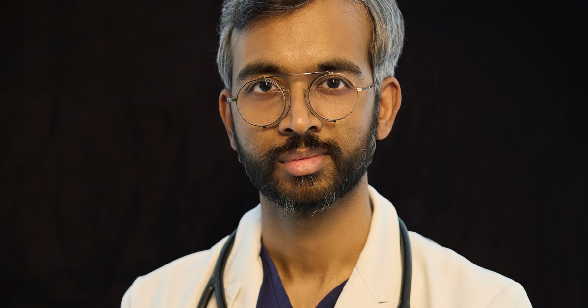 Portrait of Dr. Madhav Danthala reading the WHO Global Status Report on Cancer 2026.
